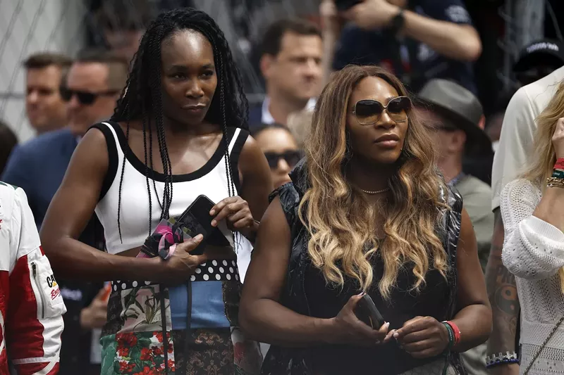 Image: Venus Williams and Serena Williams watch the grid presentation prior to the F1 Grand Prix of Miami at Miami International Autodrome on May 07, 2023 in Miami, Florida