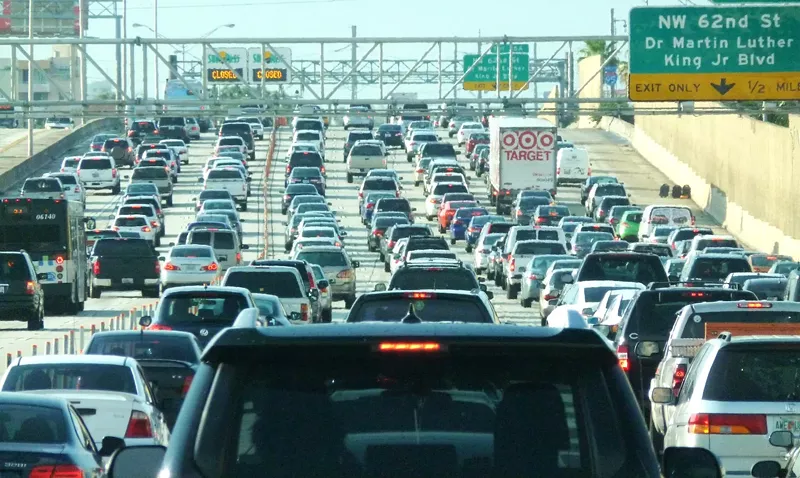 Image: cars cars cars on an urban stretch of interstate, as far as the eye can see