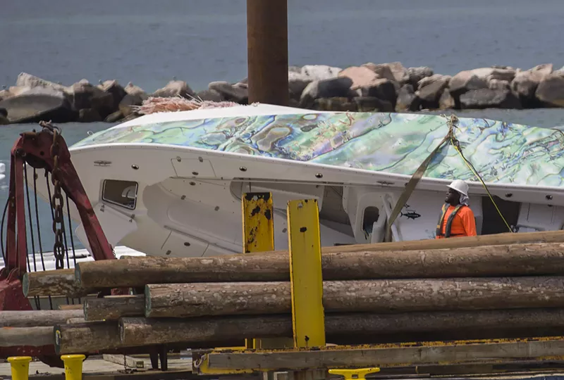 Image: A barge is used to carry a 32-foot center console boat that crashed into Government Cut’s north jetty, killing three people on April 22, 2019.