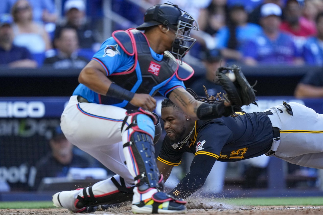 Oneil Cruz of the Pittsburgh Pirates slides into home base to score against the Miami Marlins during the tenth inning at LoanDepot park on March 31, 2024.