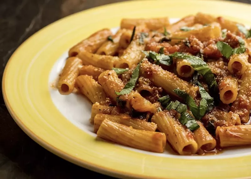 Image: a pasta dish on a yellow plate
