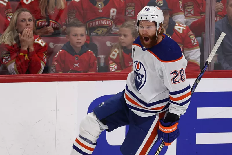 Image: Connor Brown of the Edmonton Oilers skates off in celebration after scoring in the 2024 Stanley Cup Finals. The fans in the background look dejected