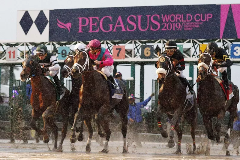 Image: Horses racing on the track at the Pegasus World Cup