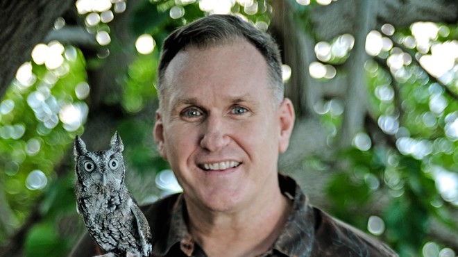 Portrait of Christoper Boykin hold a small owl