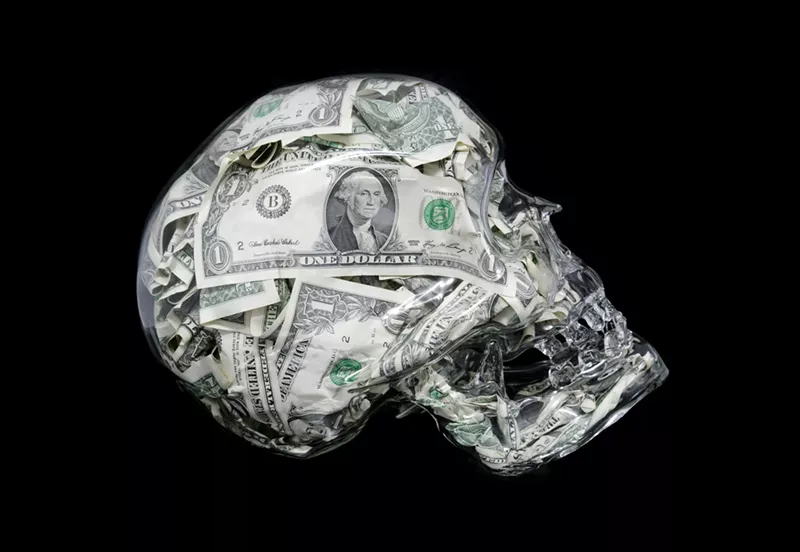 Image: A glass skull filled with U.S. dollars