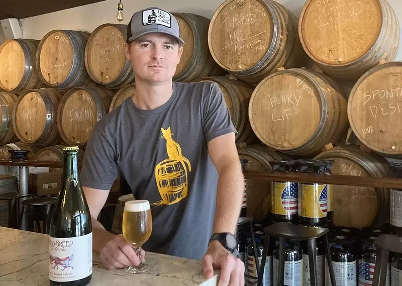 Image: Odd Breed Wild Ales' Matt Manthe with a glass of "Loup et Renard," a saison collaboration with 3 Sons Brewing Co. that won a gold medal at the 2023 Great American Beer Festival.