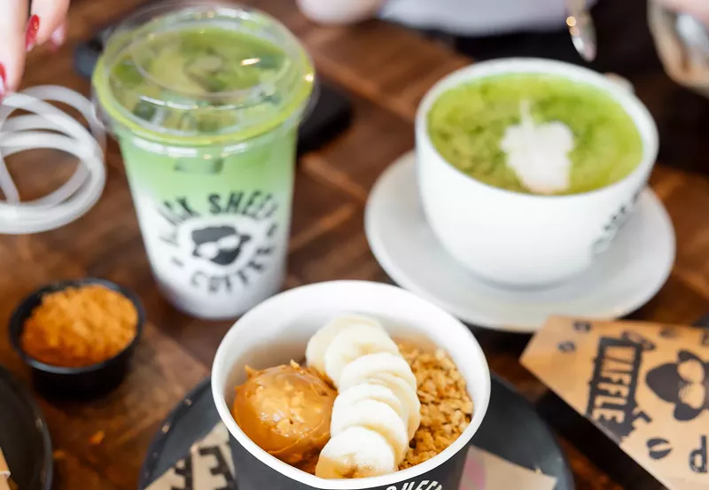 Image: matcha drinks and a fruit bowl on a table