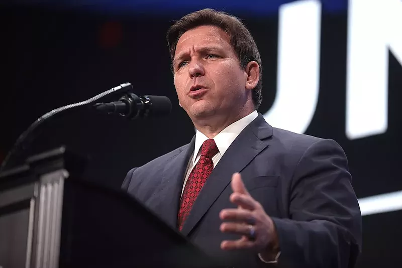 Image: Florida Gov. Ron DeSantis speaking at a "Unite & Win Rally" at Arizona Financial Theatre.