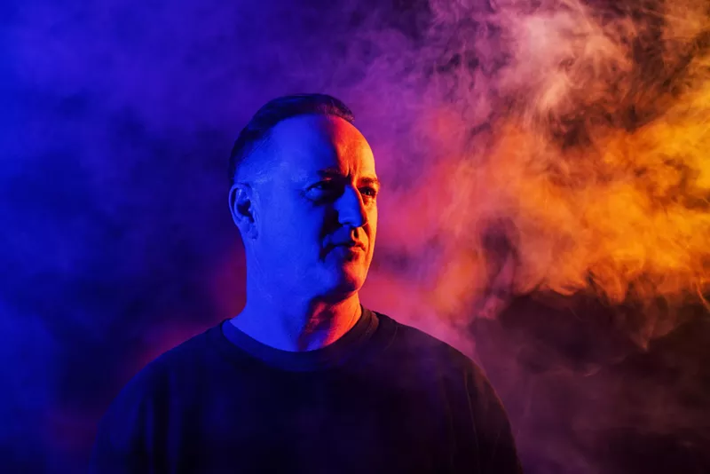 Image: Sasha covered in blue and red light