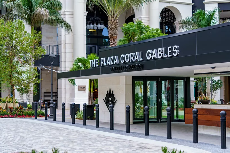 Image: A sleek front lobby entrance to a luxury development in South Florida