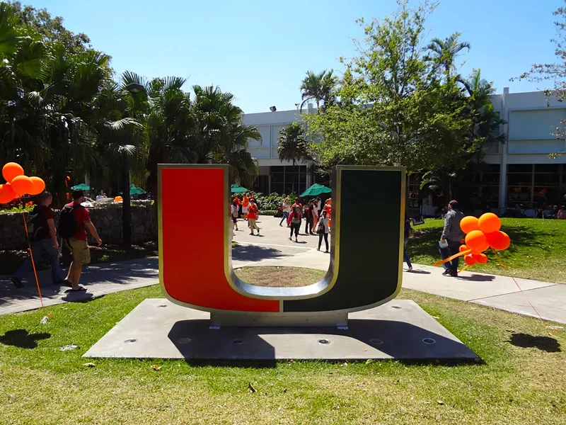 Image: Green and orange University of Miami sign on campus