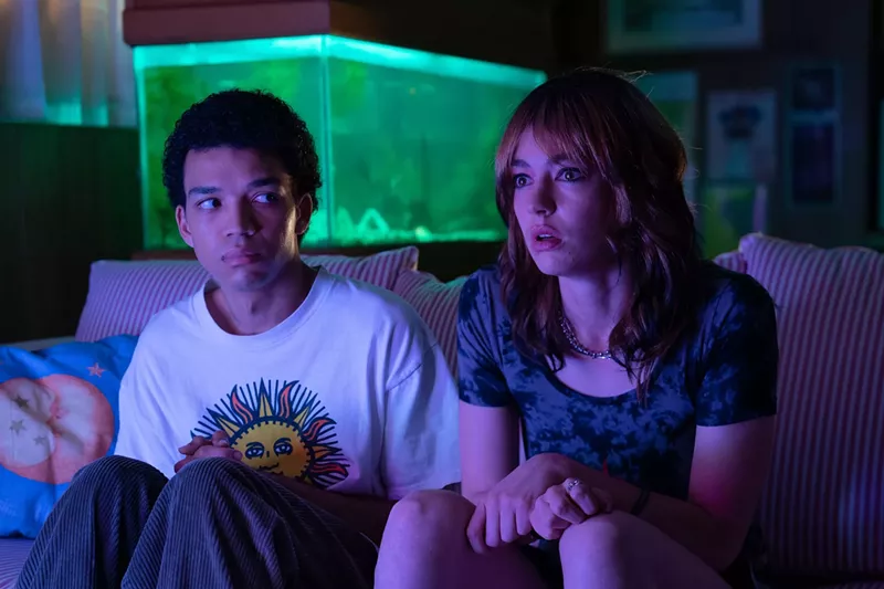 Image: Still of Justice Smith and Brigette Lundy-Paine still on a couch