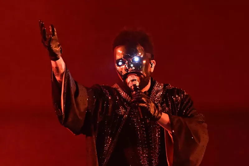 Image: Artist the Weeknd performing with a mask.