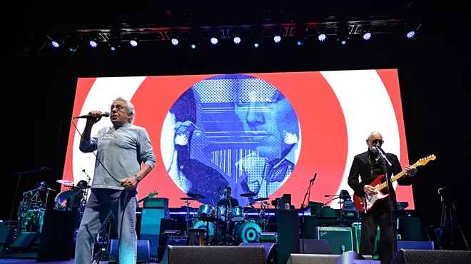 The Who band playing on stage.