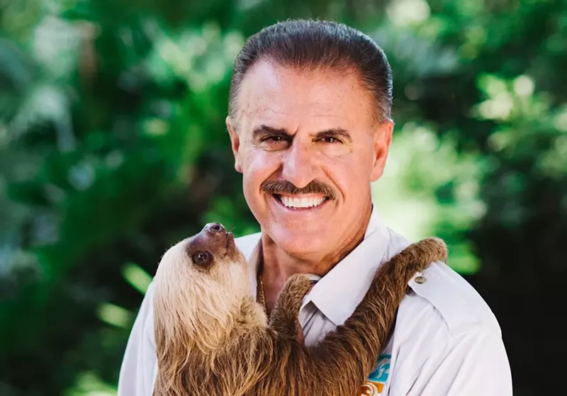 Image: headshot of conservationist Ron Magill holding a sloth