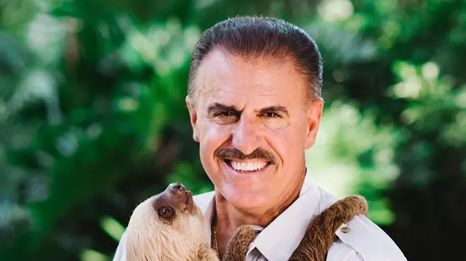 headshot of conservationist Ron Magill holding a sloth