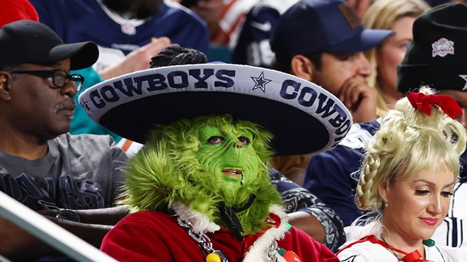 A football fan in an elaborate Grinch costume