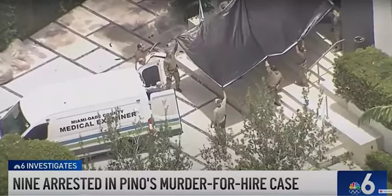 Image: Medical examiner's truck pulls up at Sergio Pino's home after he was found dead during an FBI raid