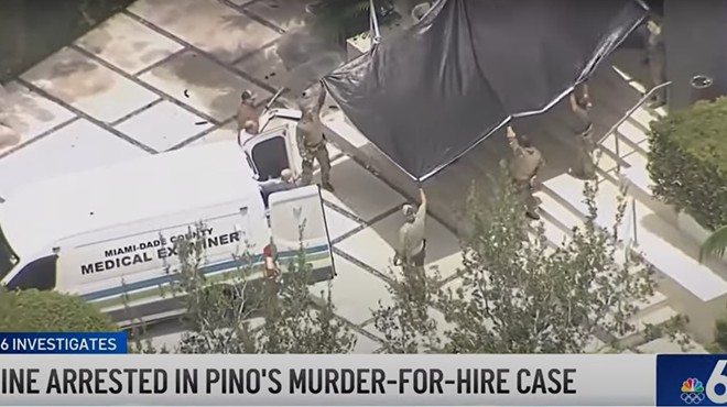 Medical examiner's truck pulls up at Sergio Pino's home after he was found dead during an FBI raid