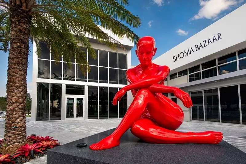 Image: A giant statue greets guests at the entrance to Shoma Bazaar.