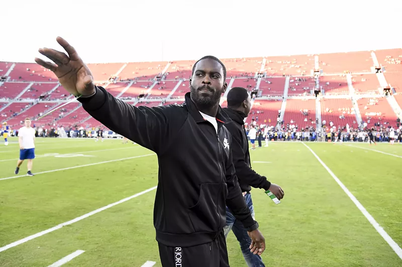 Image: Former NFL quarterback Michael Vick greets fans prior to a game at Los Angeles Memorial Coliseum on November 17, 2019.