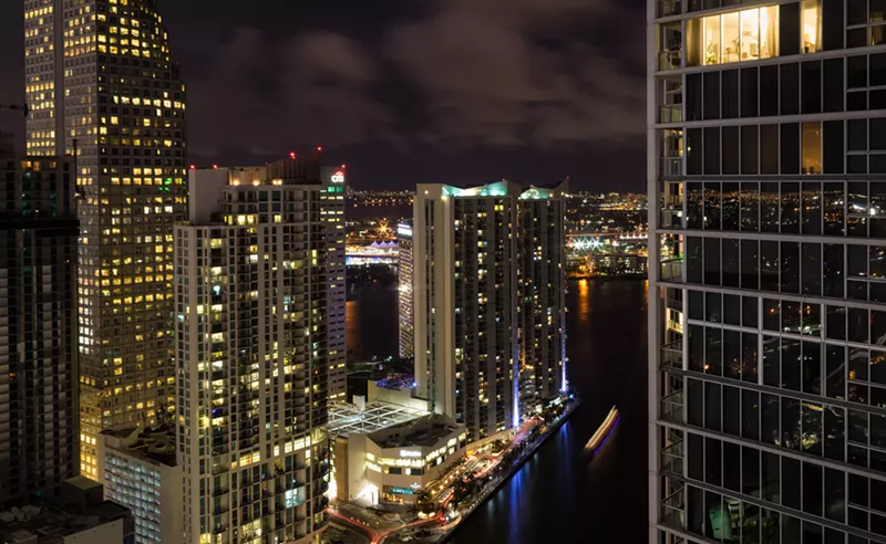 Image: The towers of Miami's Brickell district lit up at night.