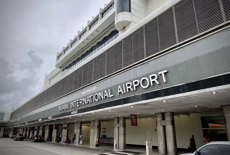 Image: 2021 photo of the exterior of Miami International airport, showing the sign