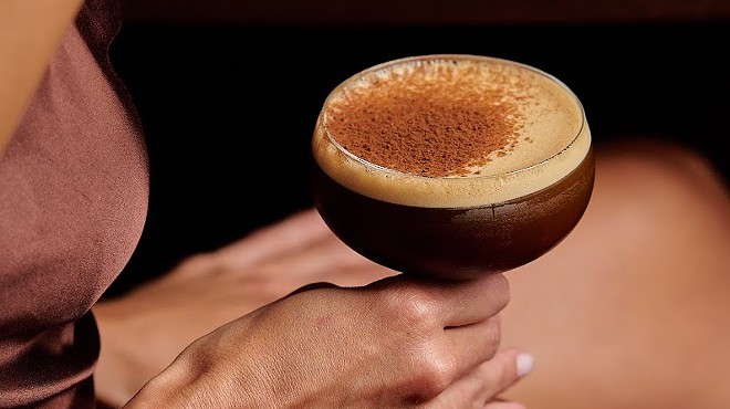 A woman holding a coffee cocktail