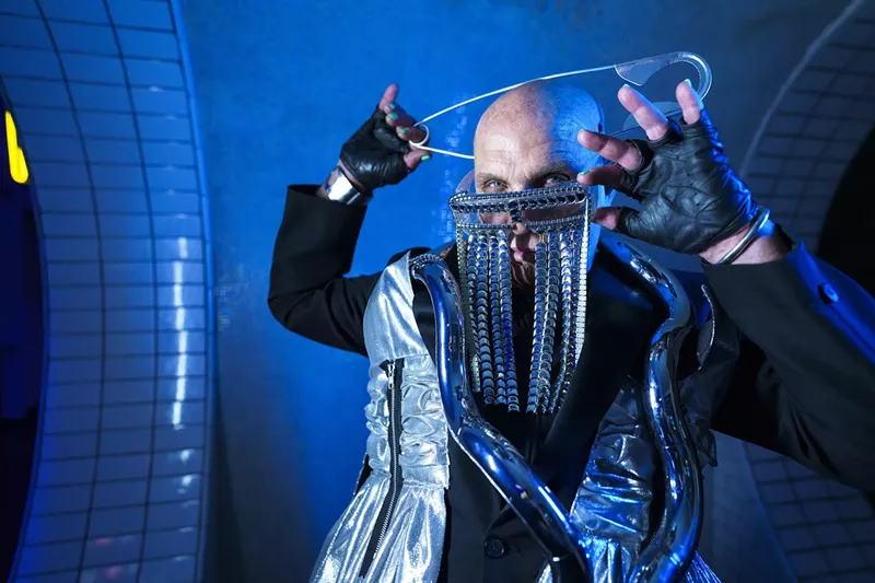 Image: Alan T poses with a huge pin on his head and glasses with chains dropping down