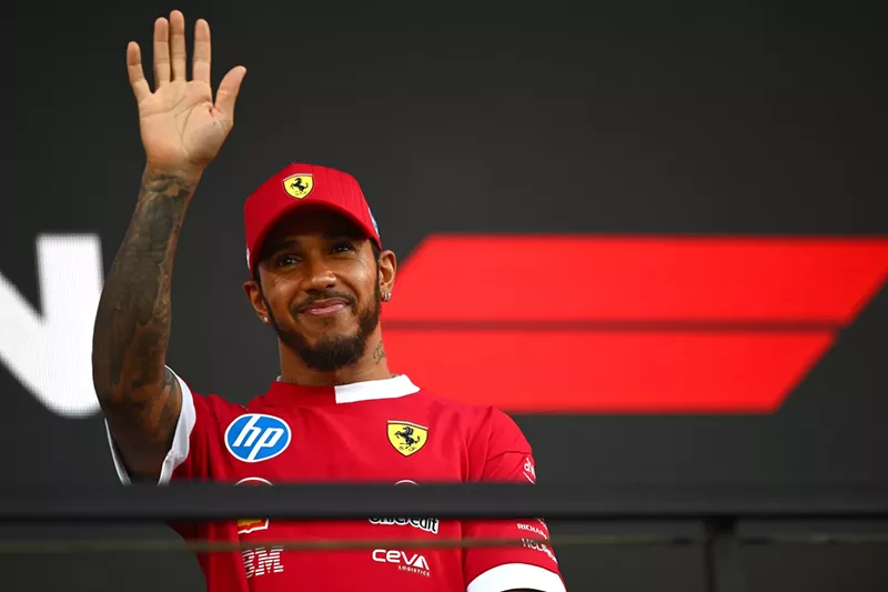 Image: F1 driver Lewis Hamilton waves at a crowd