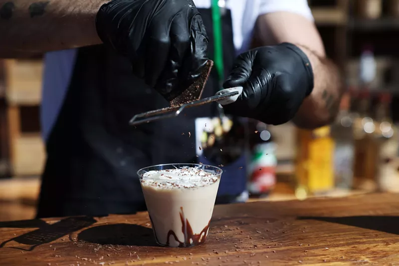 Image: Hands shaving chocolate on drink