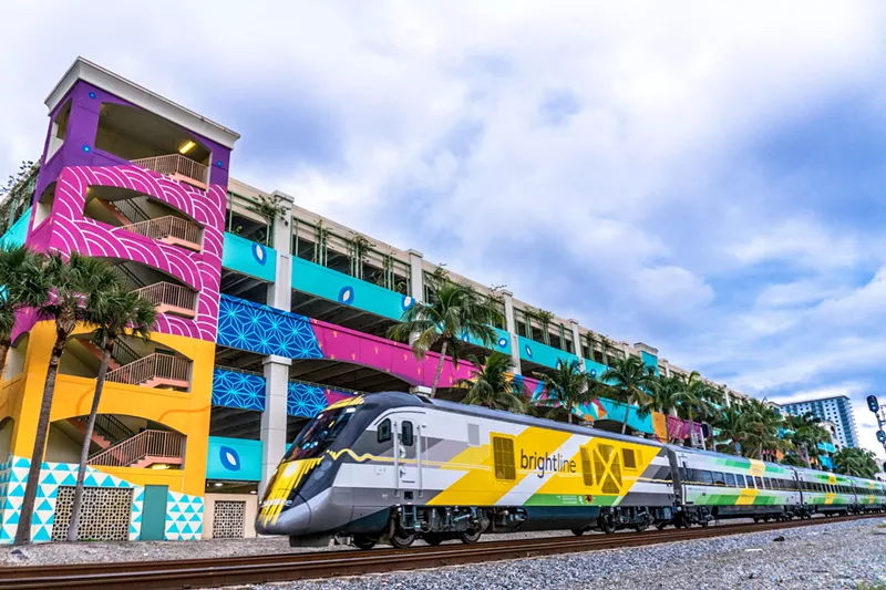 Image: Brightline train in front of colorful parking garage in West Palm Beach