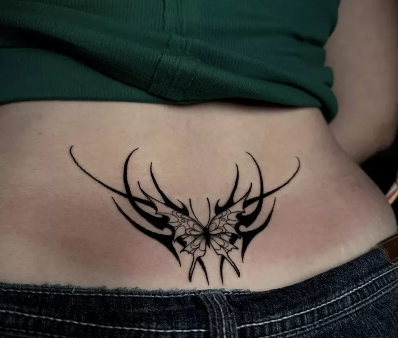 Image: Woman with a tribal style lower back tattoo