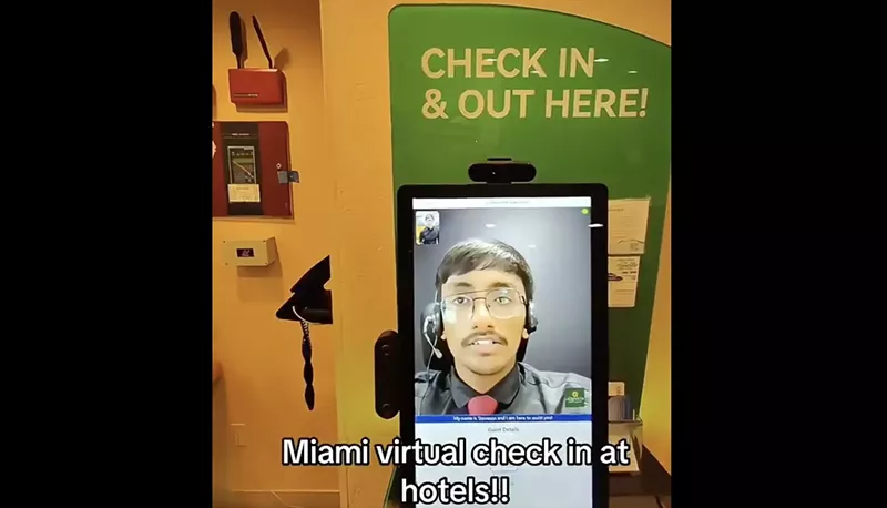 Image: A remote receptionist talks with a guest at a Miami hotel.