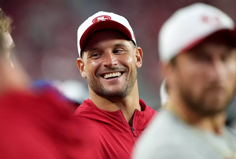 Image: Nick Bosa of the San Francisco 49ers, clad in athleisure gear, looks on from the sidelines against the Denver Broncos in the second half during the NFL preseason game at Levi's Stadium on August 09, 2025, in Santa Clara, California.