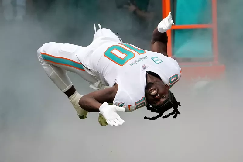 Image: Miami Dolphins wide receiver Tyreek Hill, captured mid-backflip during the team's player introductions at Hard Rock Stadium in November 2022.