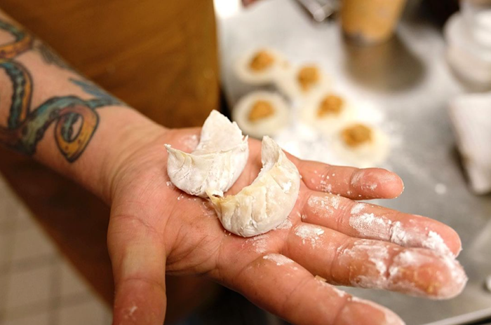 Hand-formed dumplings are a team effort at newly opened Zitz Sum in Coral Gables. - PHOTO BY FUJI FILM GIRL