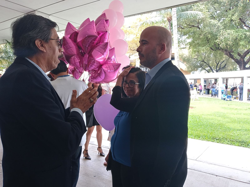 Orlando Duran speaks to Eric Rojas-Gonzalez, nephew of Osvaldo Gonzalez, who died in the bridge collapse. - PHOTO BY JOSHUA CEBALLOS