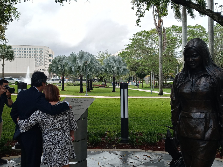 Orlando and Gina Duran stand beside a statue of their daughter, Alexa, who died on March 15, 2018. - PHOTO BY JOSHUA CEBALLOS