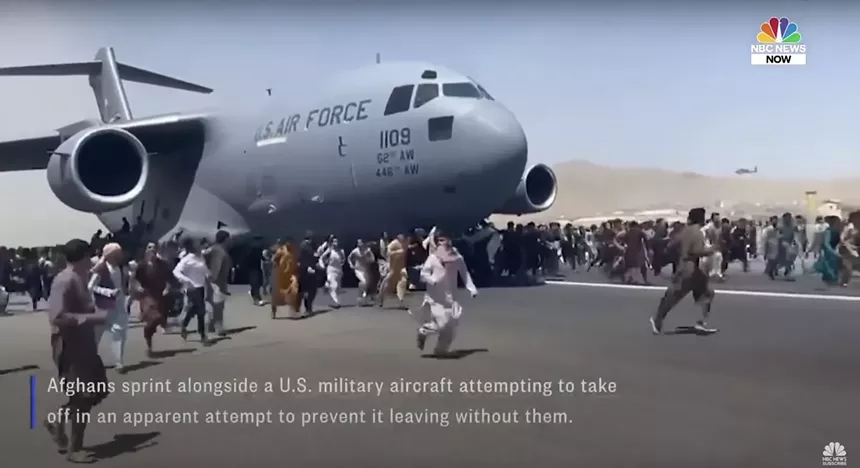 Footage from August 2021 shows Afghans sprinting along the tarmac in an apparent attempt to prevent a U.S. military aircraft from taking off without them. - NBC NEWS SCREENSHOT VIA YOUTUBE