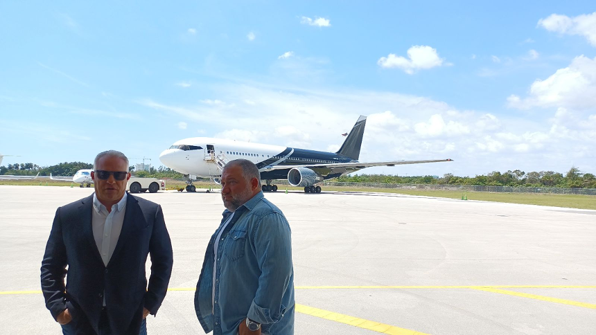 Billionaire John H. Ruiz (left) with VIP Completions Chairman Ben Shirazi (right) in front of Ruiz's recently refurbished private Boeing 767. - PHOTO BY JOSHUA CEBALLOS