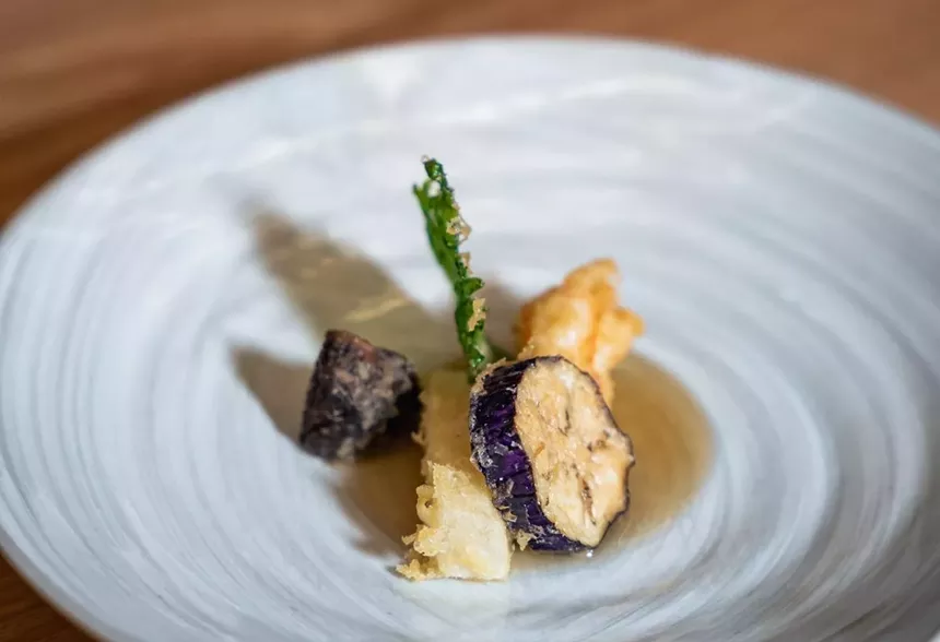 An assortment of tempura vegetables served on a white plate at Ogawa