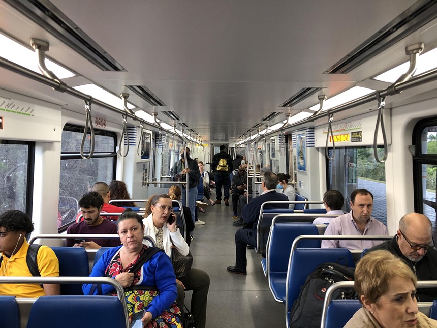 Passengers sitting inside a Metrorail train in Miami