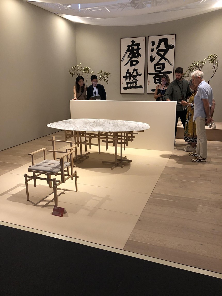 Aman Interiors booth at Design Miami, featuring a chair and table designed by Japanese architect Kengo Kuma