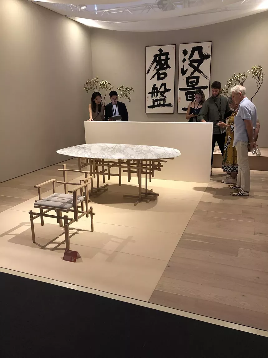 Aman Interiors booth at Design Miami, featuring a chair and table designed by Japanese architect Kengo Kuma