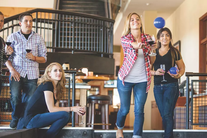 People play bocce at Pinstripes Aventura while drinking wine