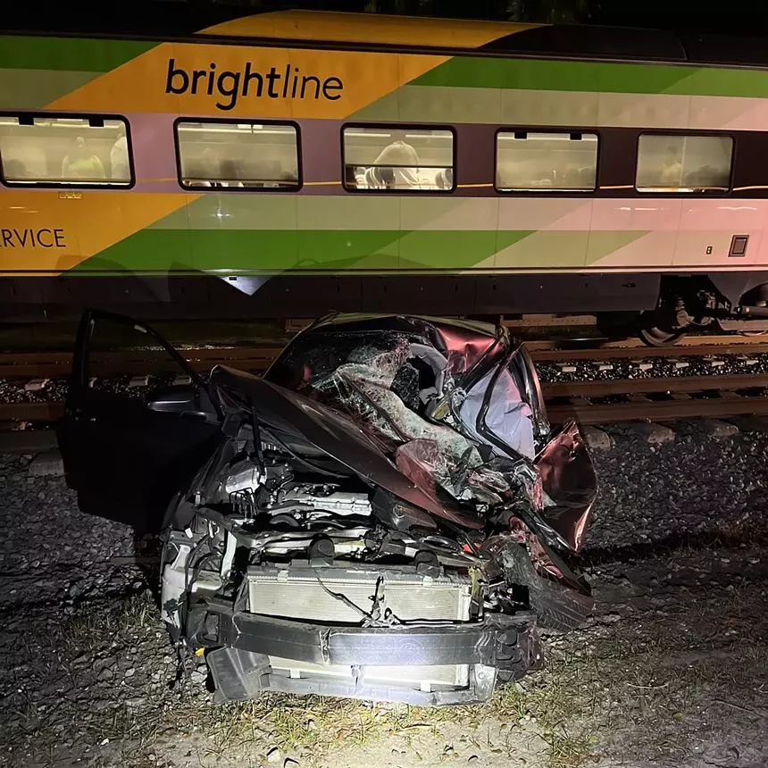 A heavily damaged vehicle following a collision with a Brightline train.