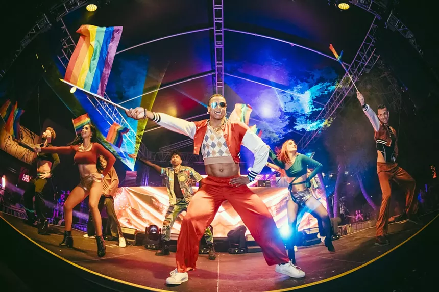 Dancers wave the Pride flag on stage at Dreamland in Miami.