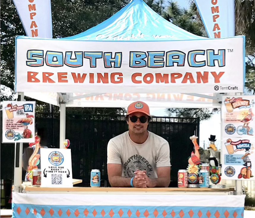 A man in a hat at a stand