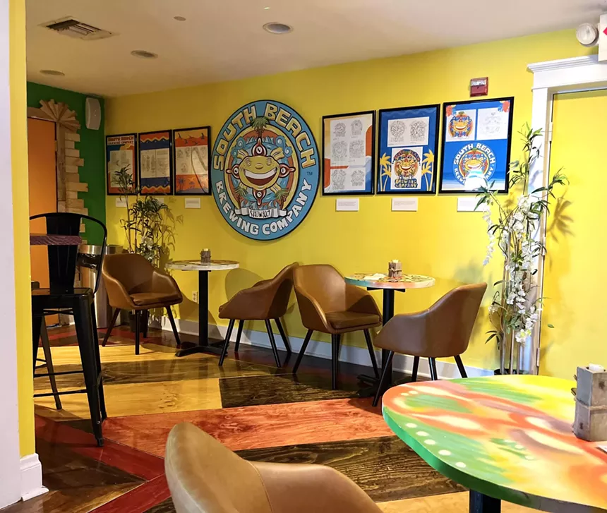 A yellow room with chairs and tables